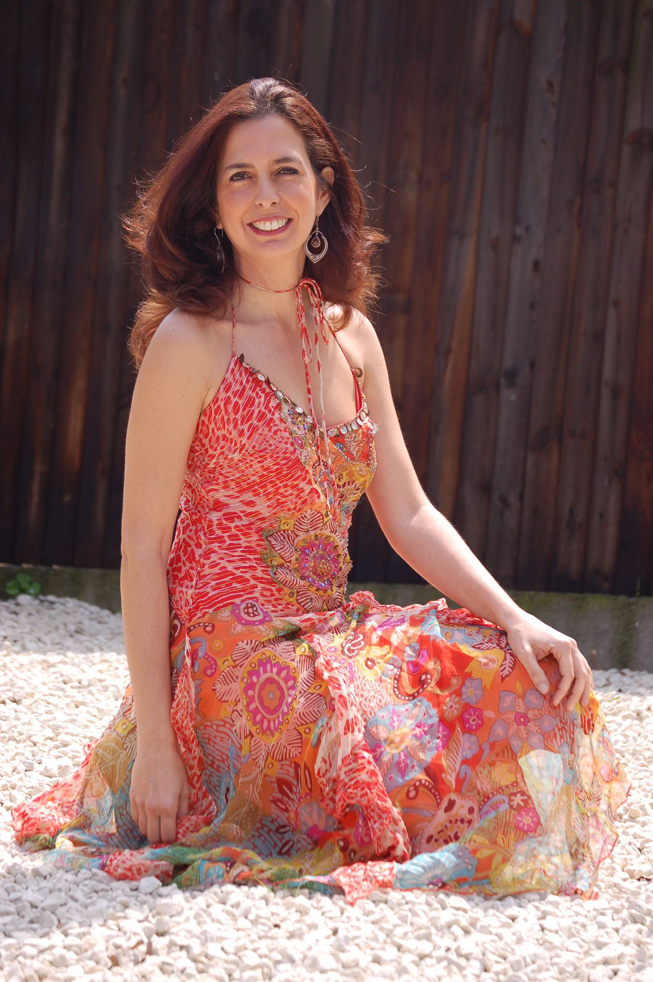 portrait of clara rodriguez in a garden wearing a floral dress