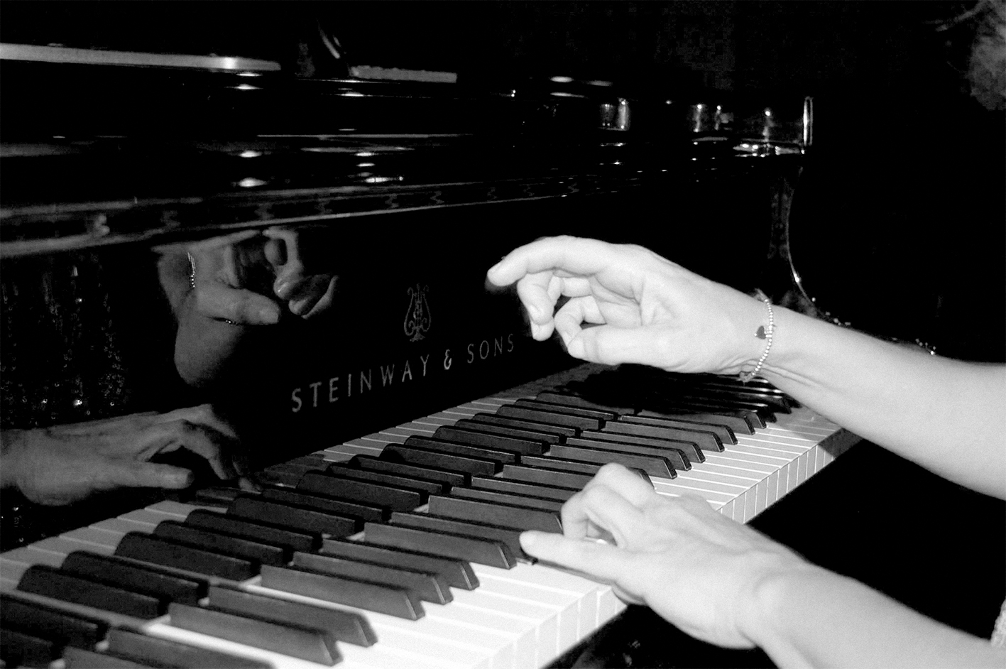 hands playing a piano